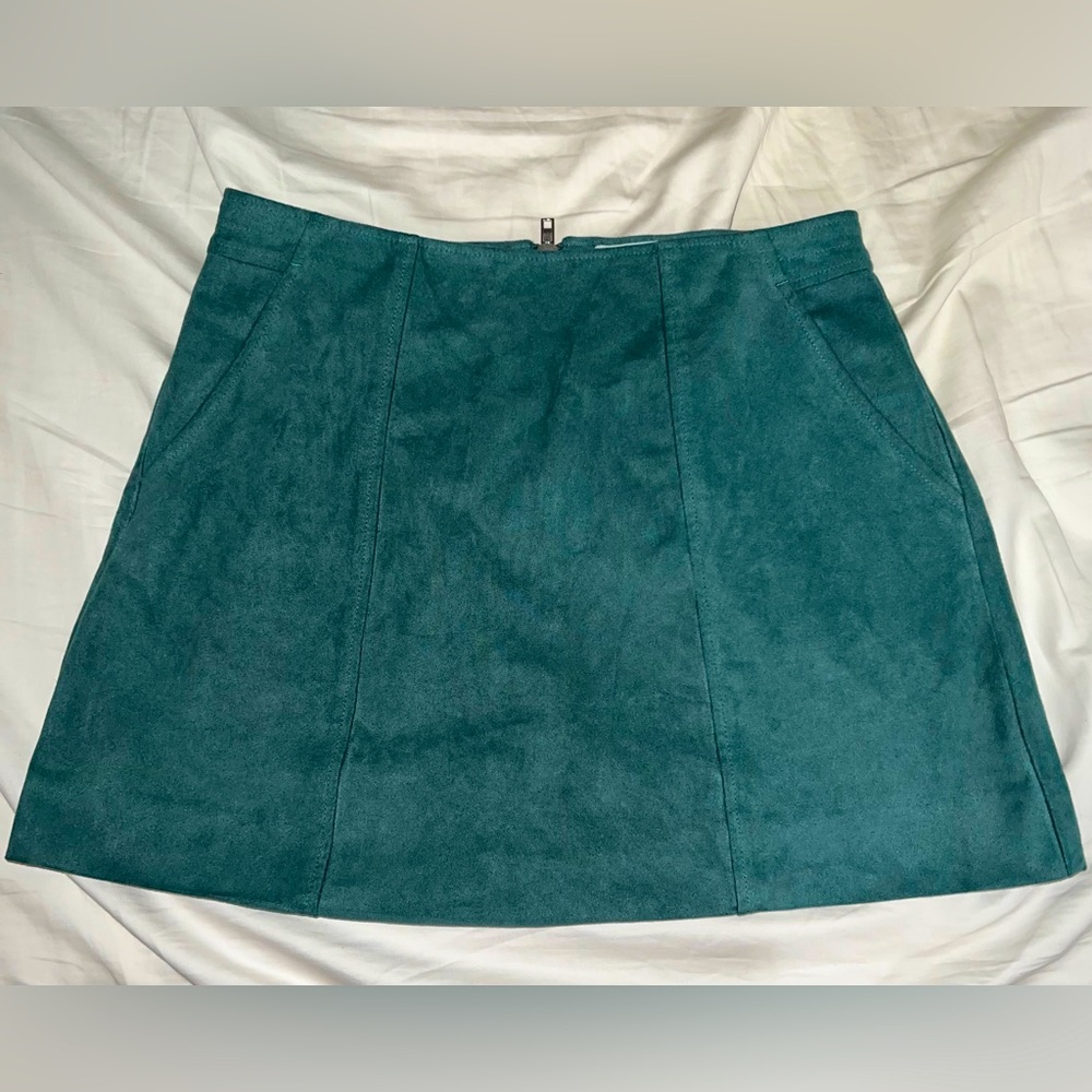Kendall and Kylie Swede green mini skirt.